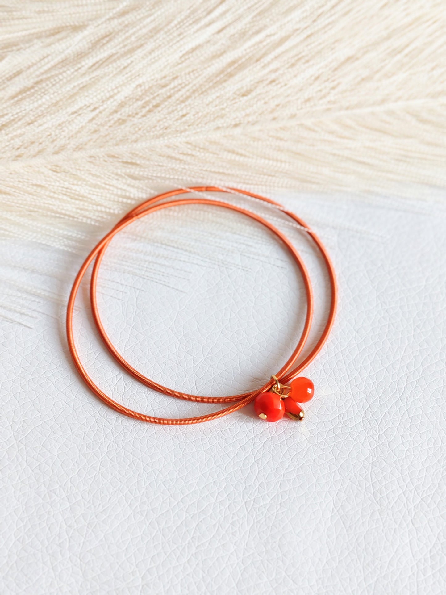 Bracciale elastico in acciaio arancio bruciato